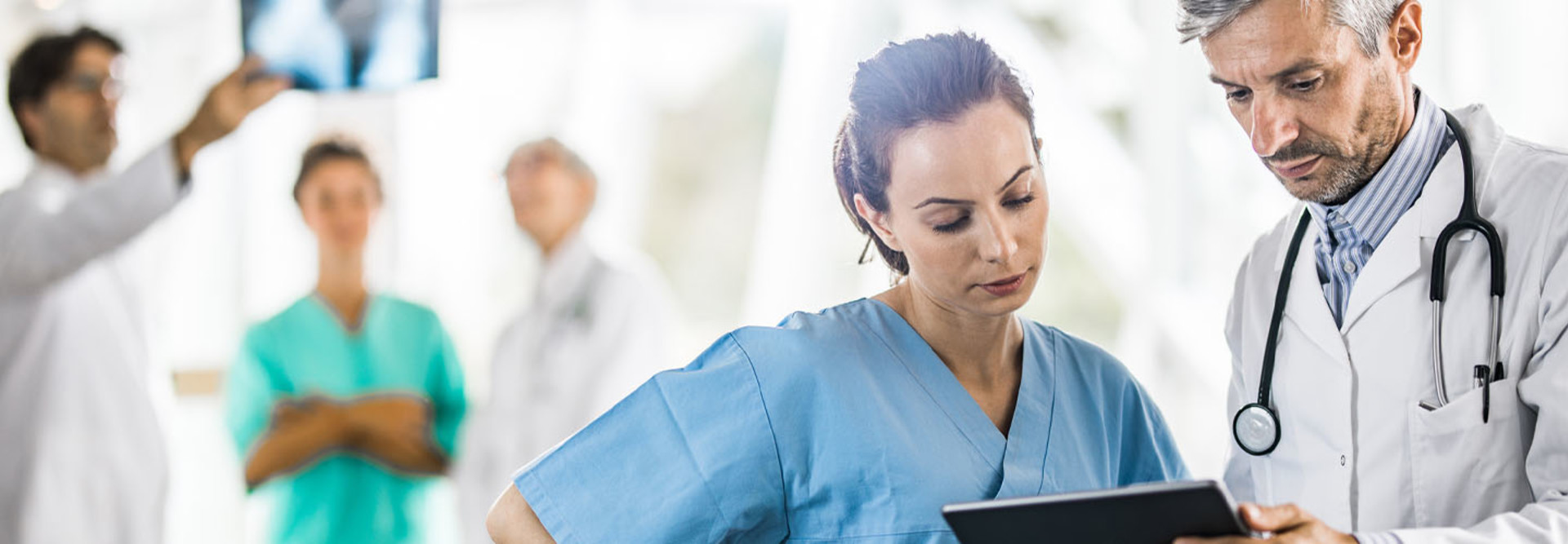 Medical experts cooperating while using digital tablet