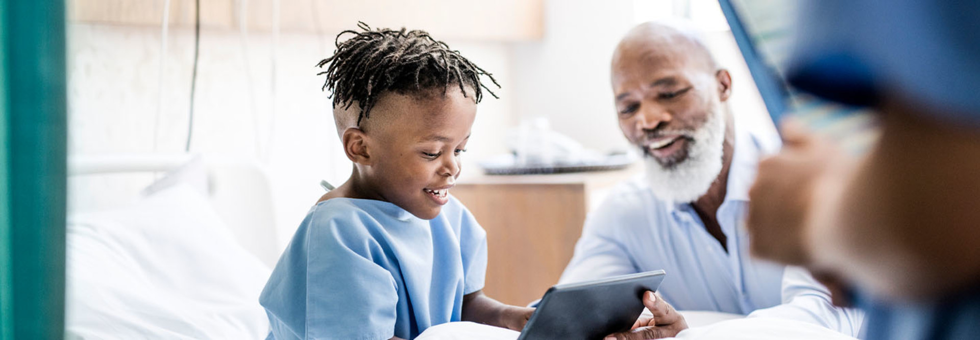 Patient using tablet in hospital room