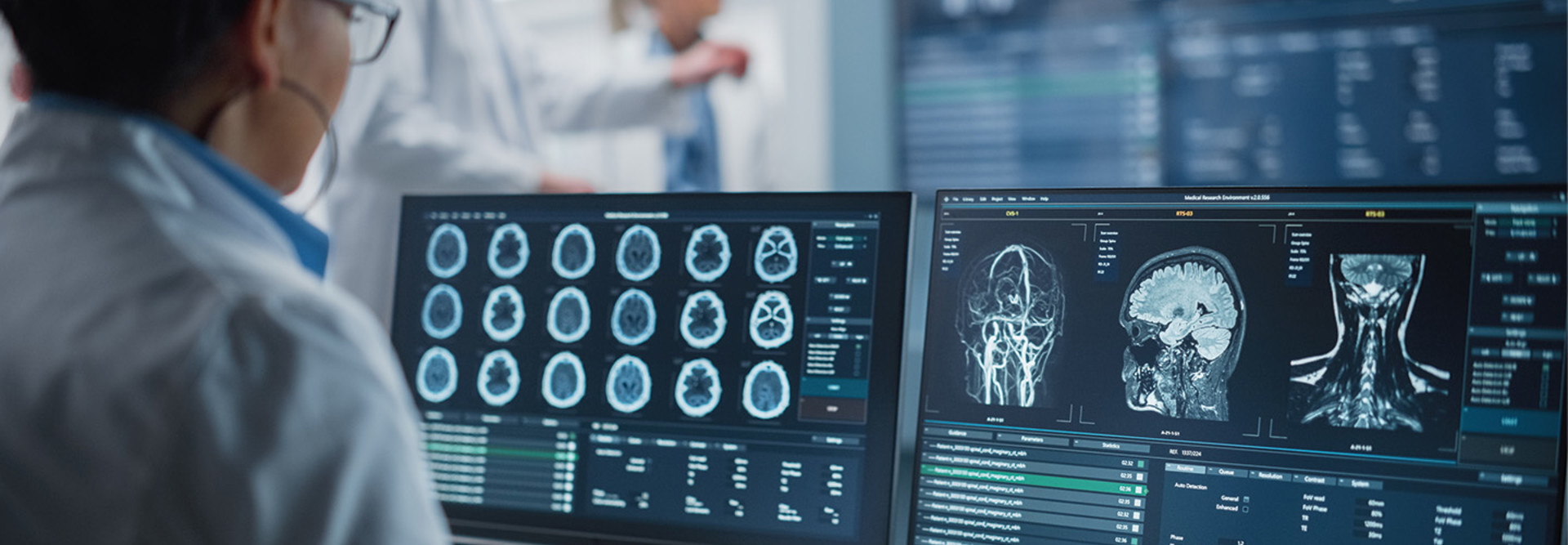 doctor examines medical images on several monitors