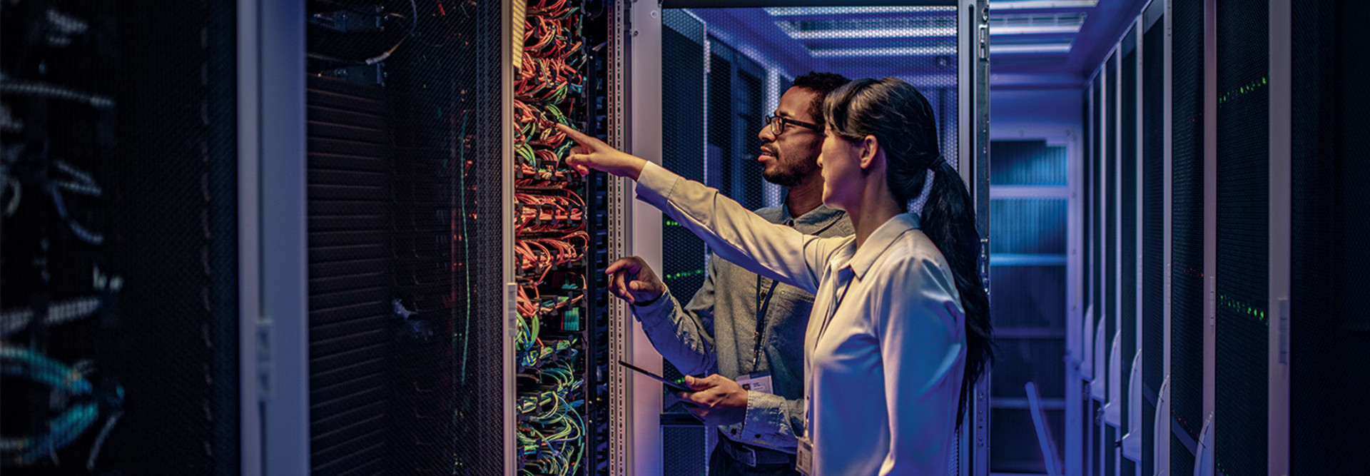 two IT experts assess a data center