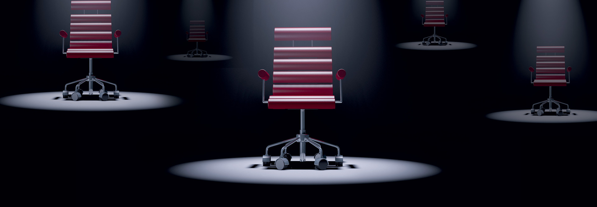 red office chair spotlit in a dark room
