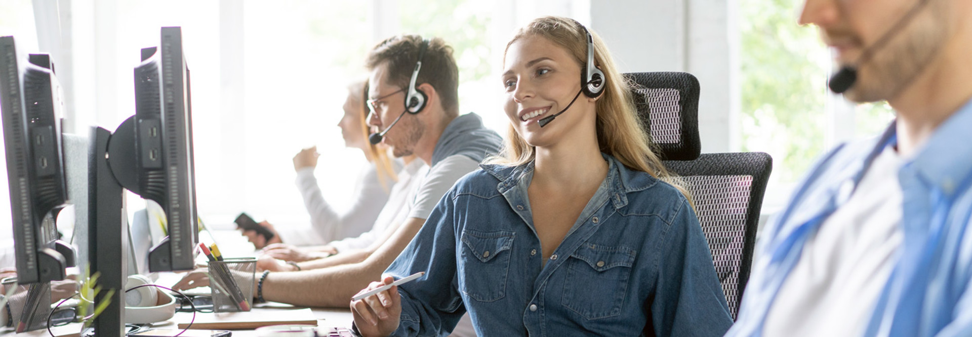 Woman uses headset in call center