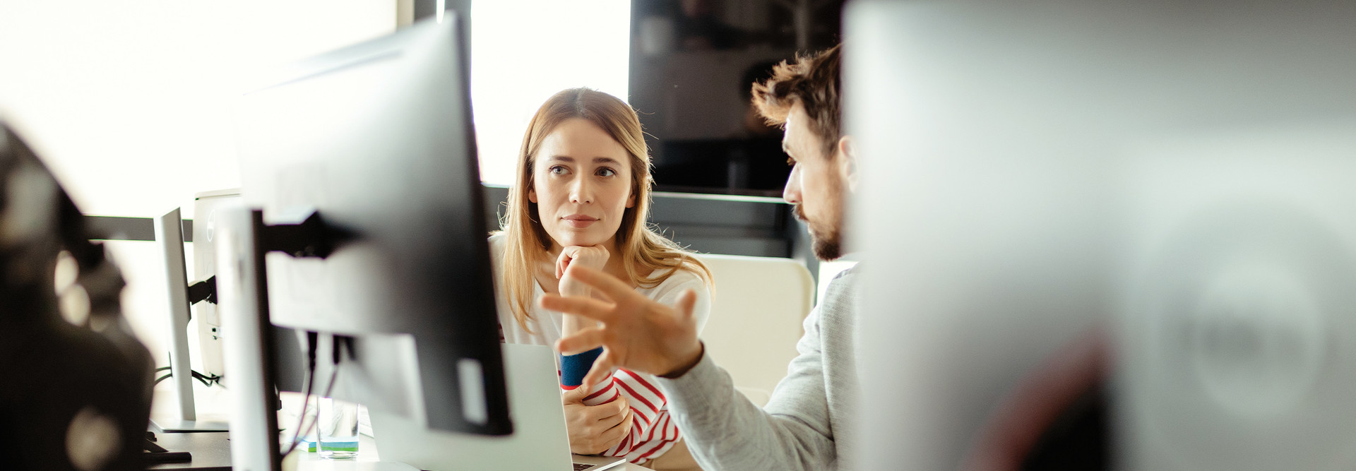 IT staff talk in front of monitor