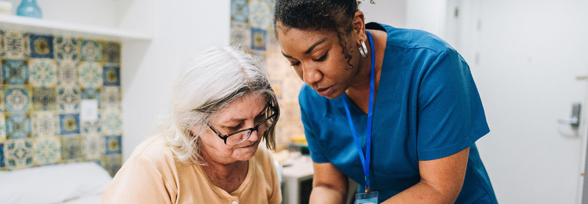 Nurse assisting senior patient