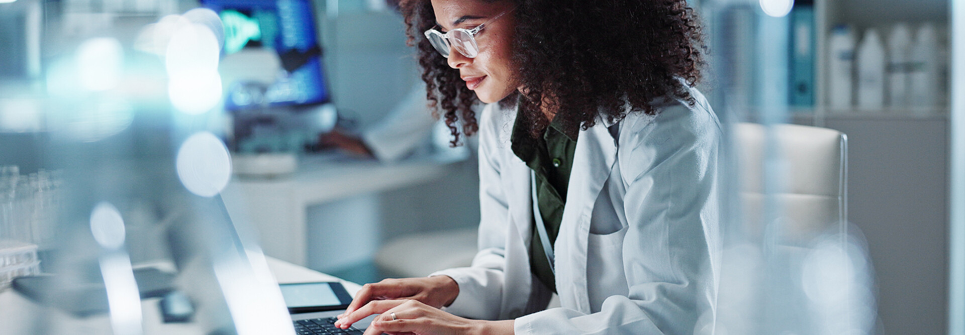 Doctor on laptop in state-of-the-art lab