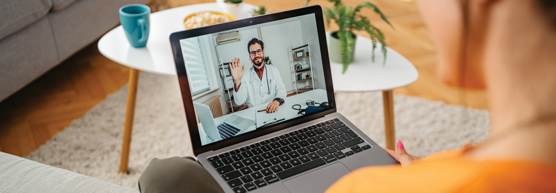 patient on laptap doing a telehealth call with doctor