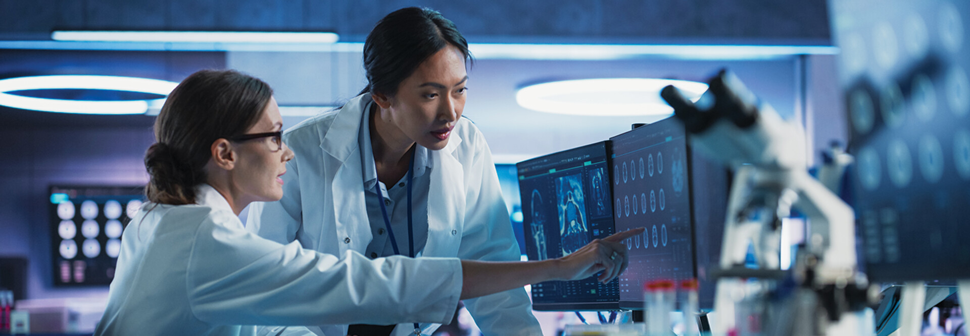 medical researchers looks at images on a monitor in a lab