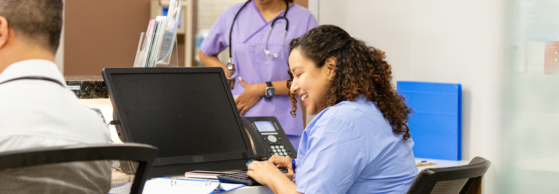 Nurse working at the front desk of a hospital