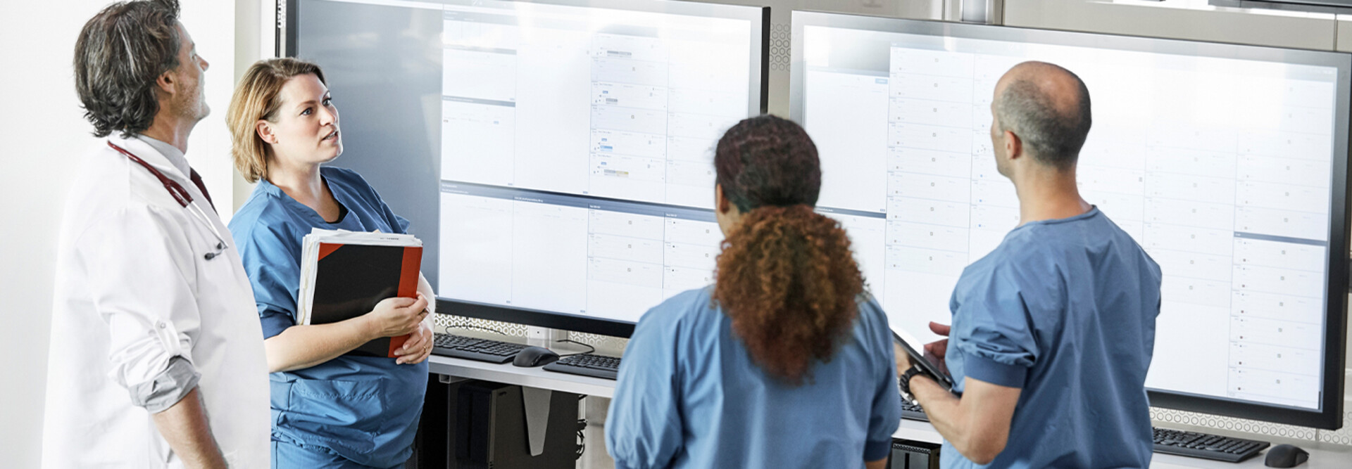 Doctors reviewing information boards