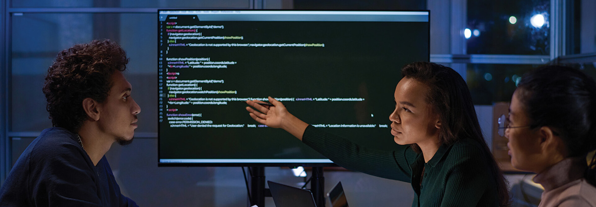 IT specialists meet and look at code