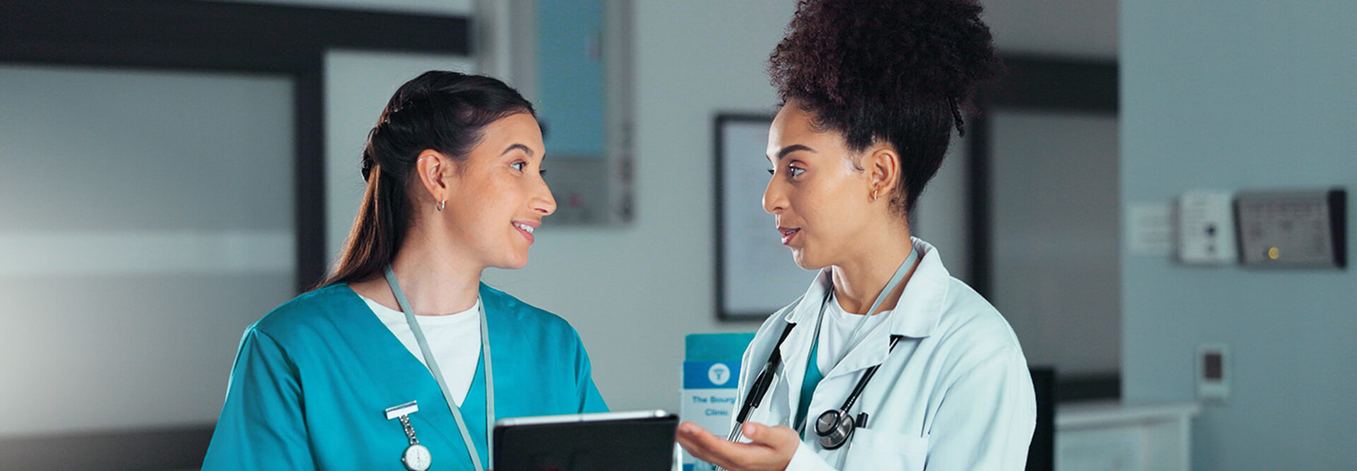 nurse and doctor collaborate over tablet