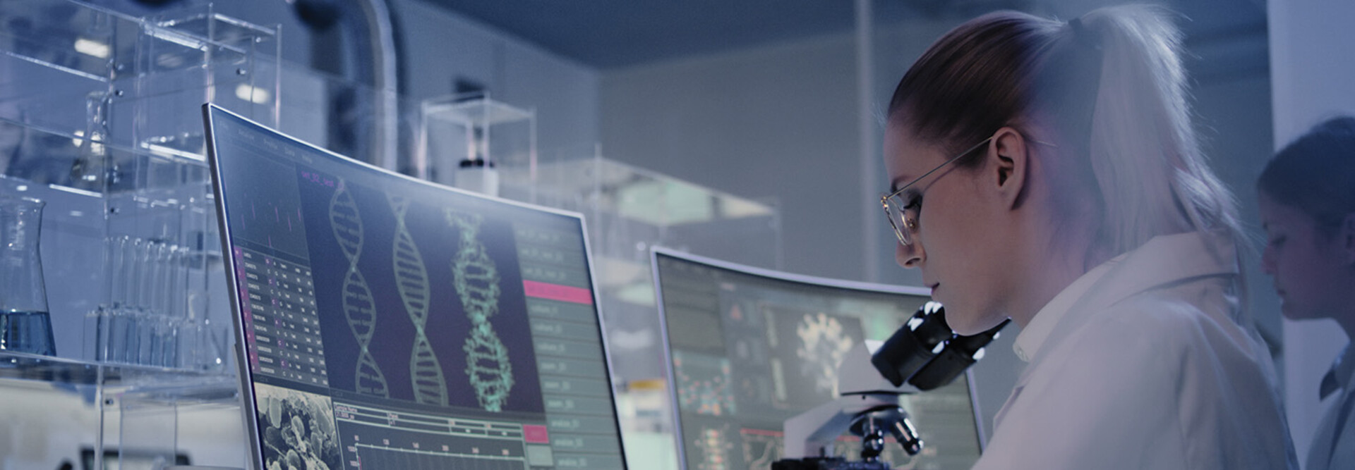 scientist looks at DNA on a computer