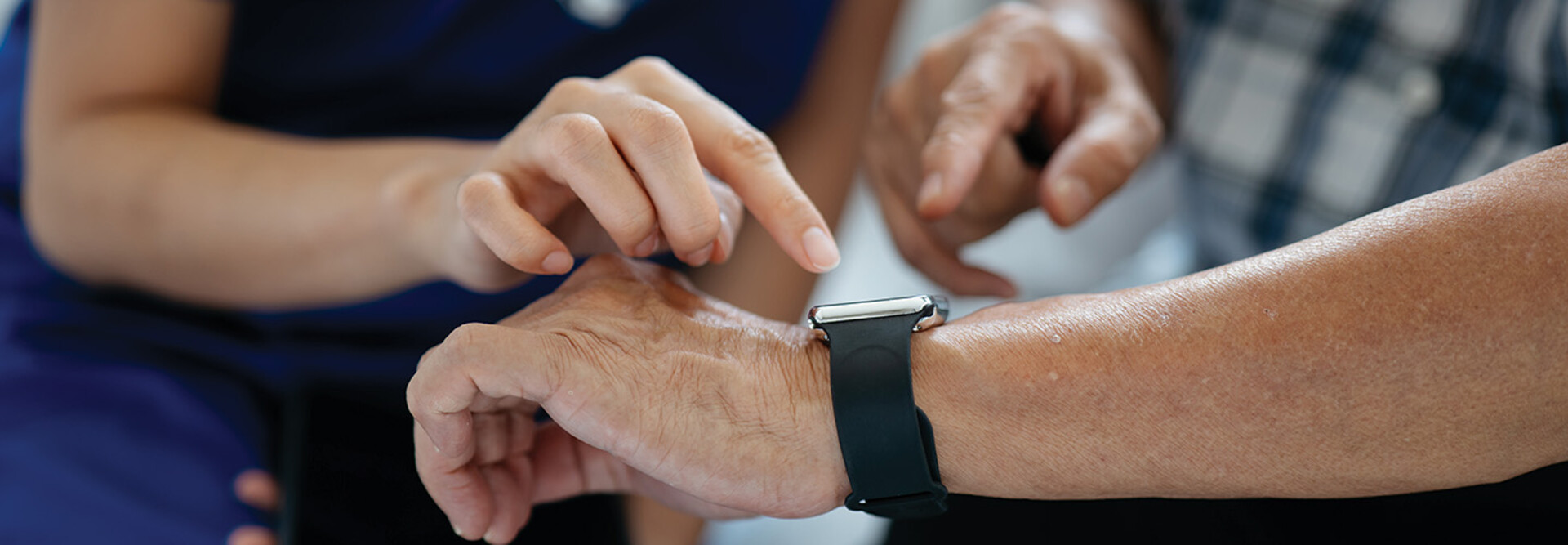 nurse helps man with wearable device