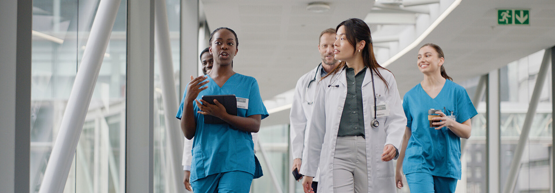 clinicians walking in hospital hallway