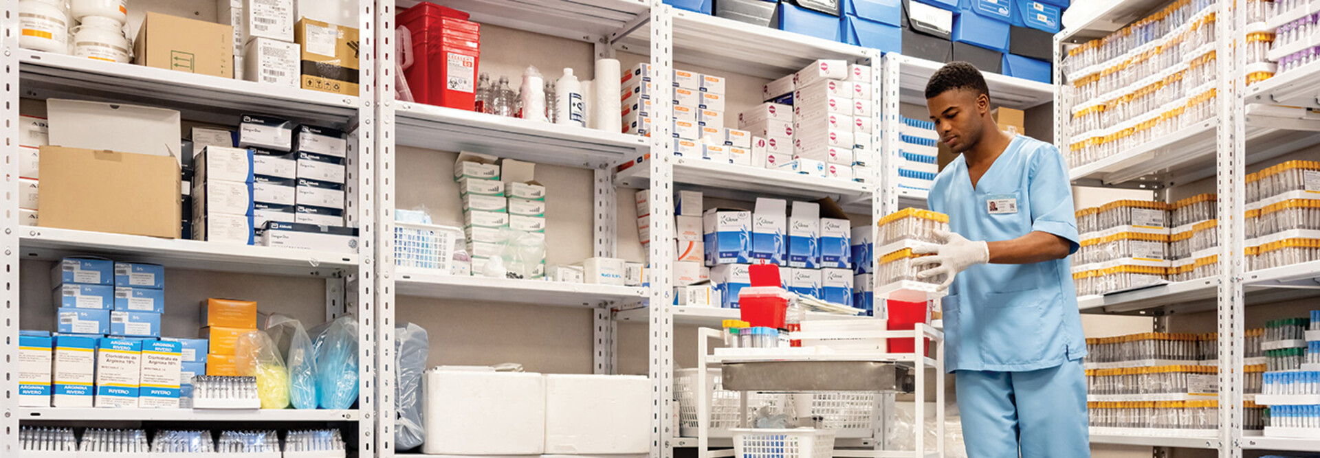 man grabs supplies in pharmacy supply room
