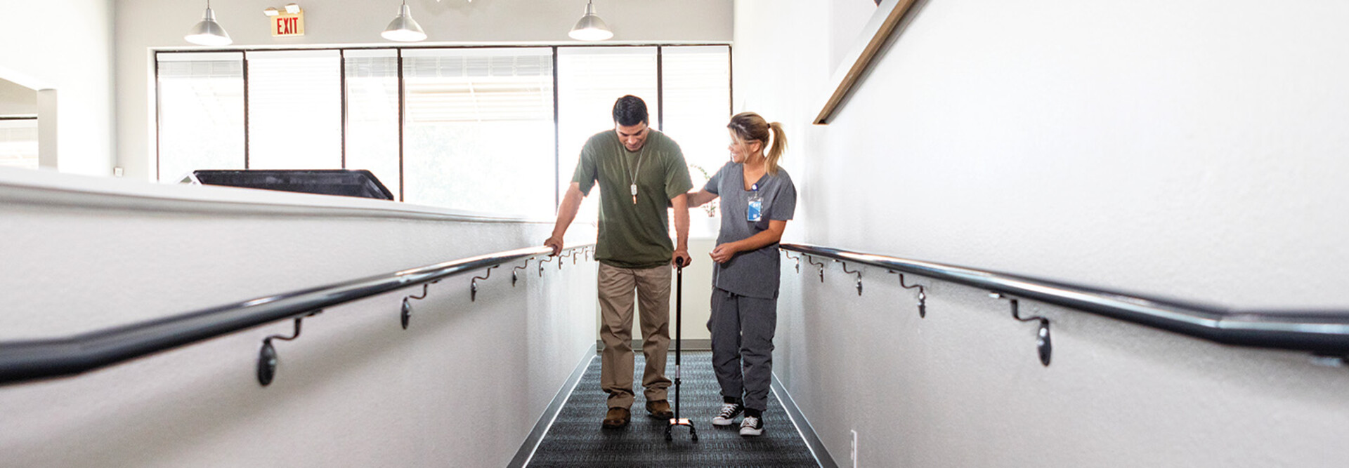 nurse helps veteran walk for rehab