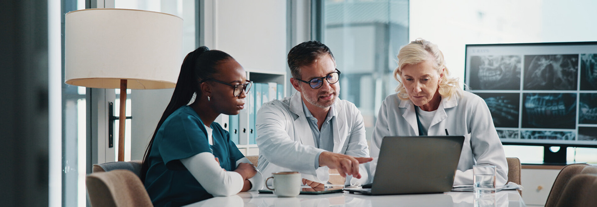 clinicians look at data on laptop