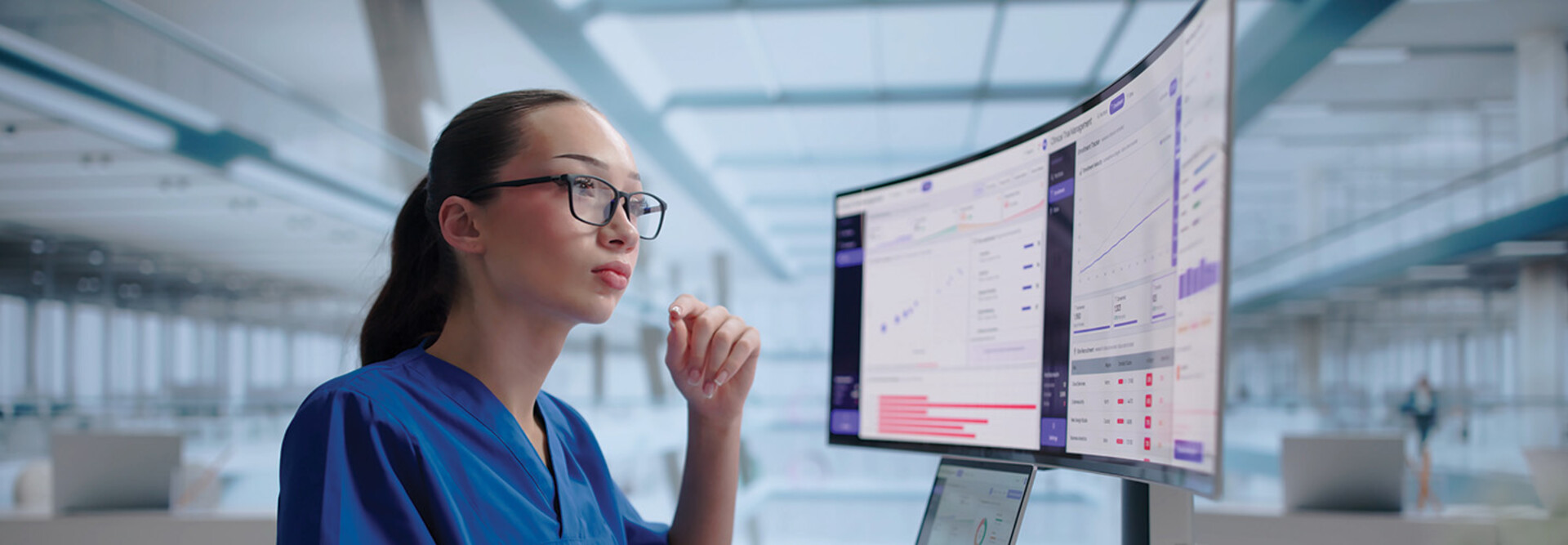 clinician looks at data on a monitor
