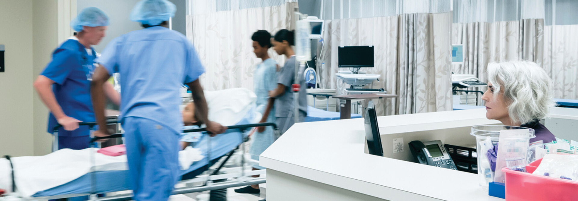 Nurses pushing hospital gurney