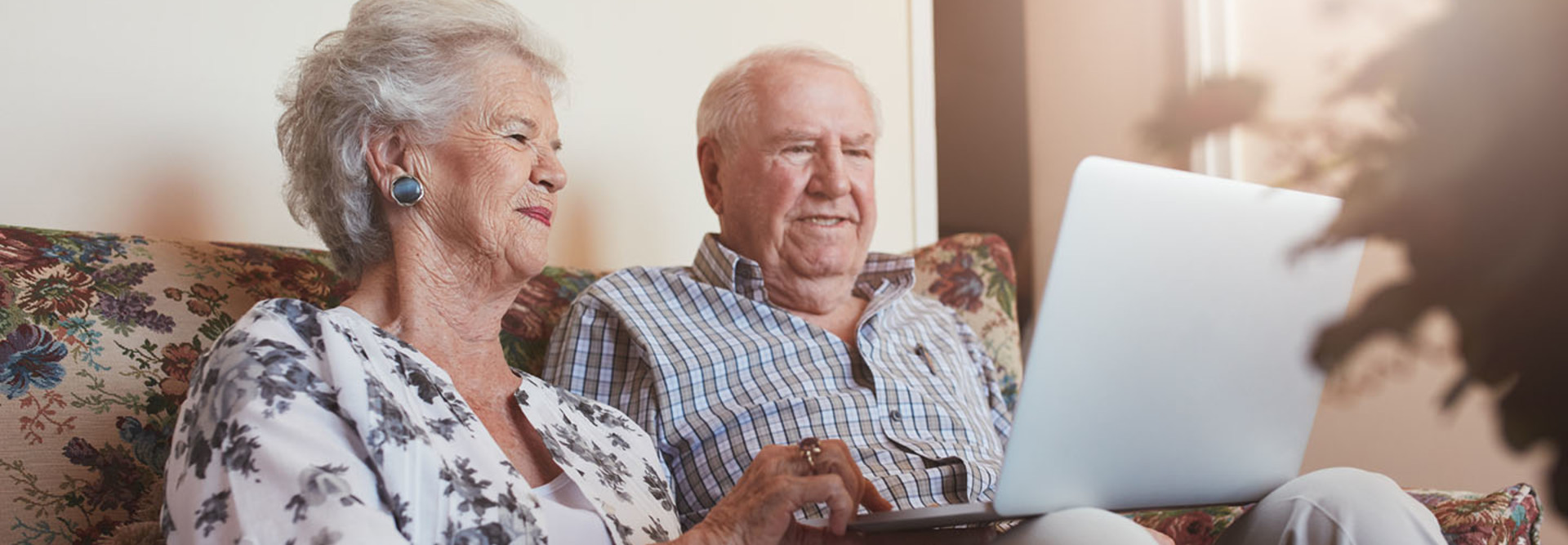 elderly couple using technology