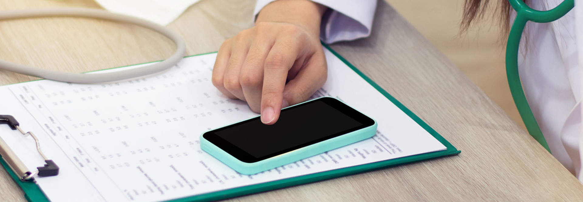 Doctor accesses patient data on smartphone as mobility in healthcare is on the rise
