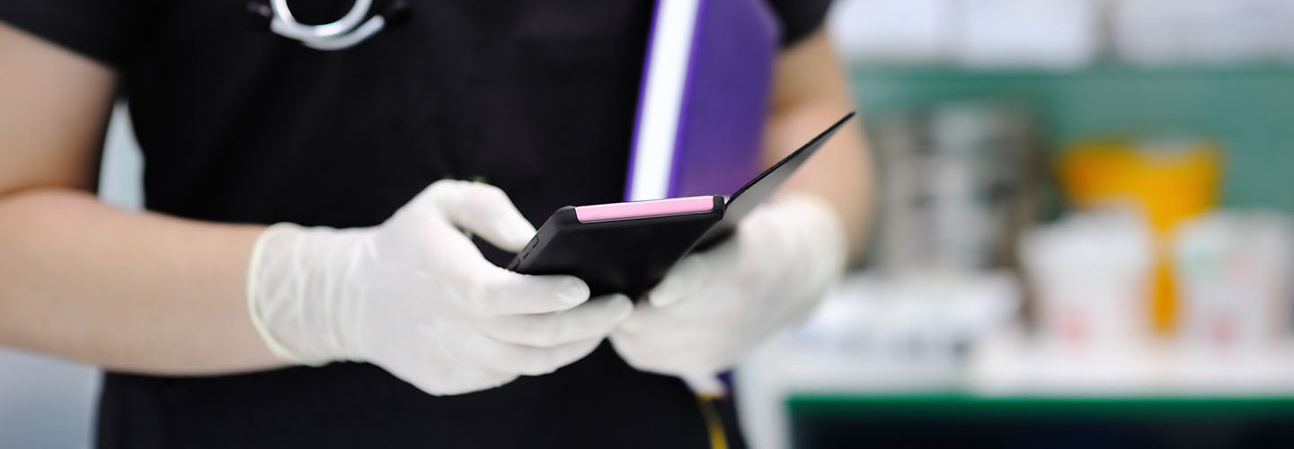 Nurse holding purple smartphone
