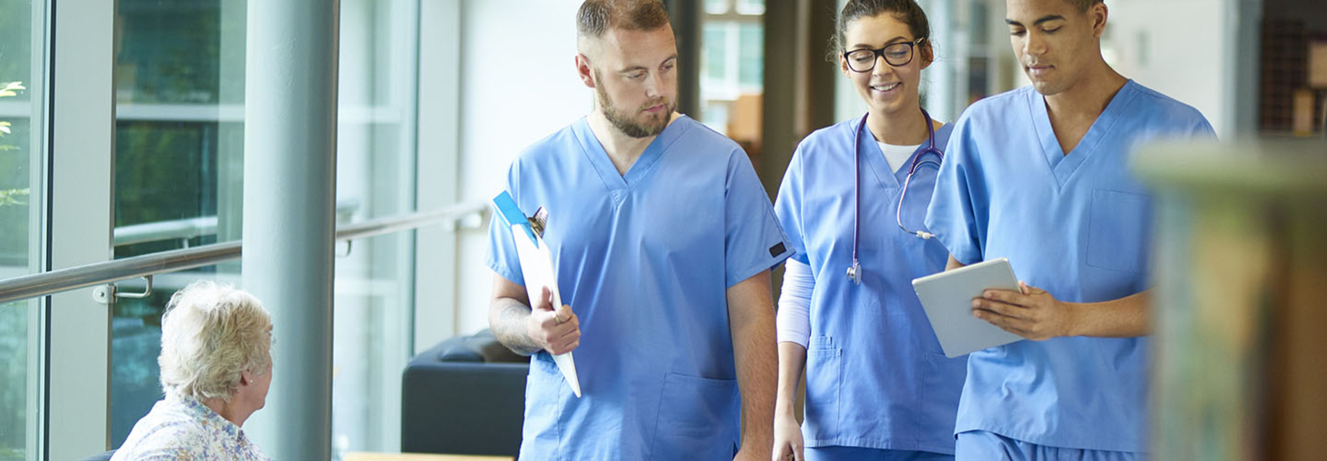 Team of doctors looking at EMR/EHR on tablet