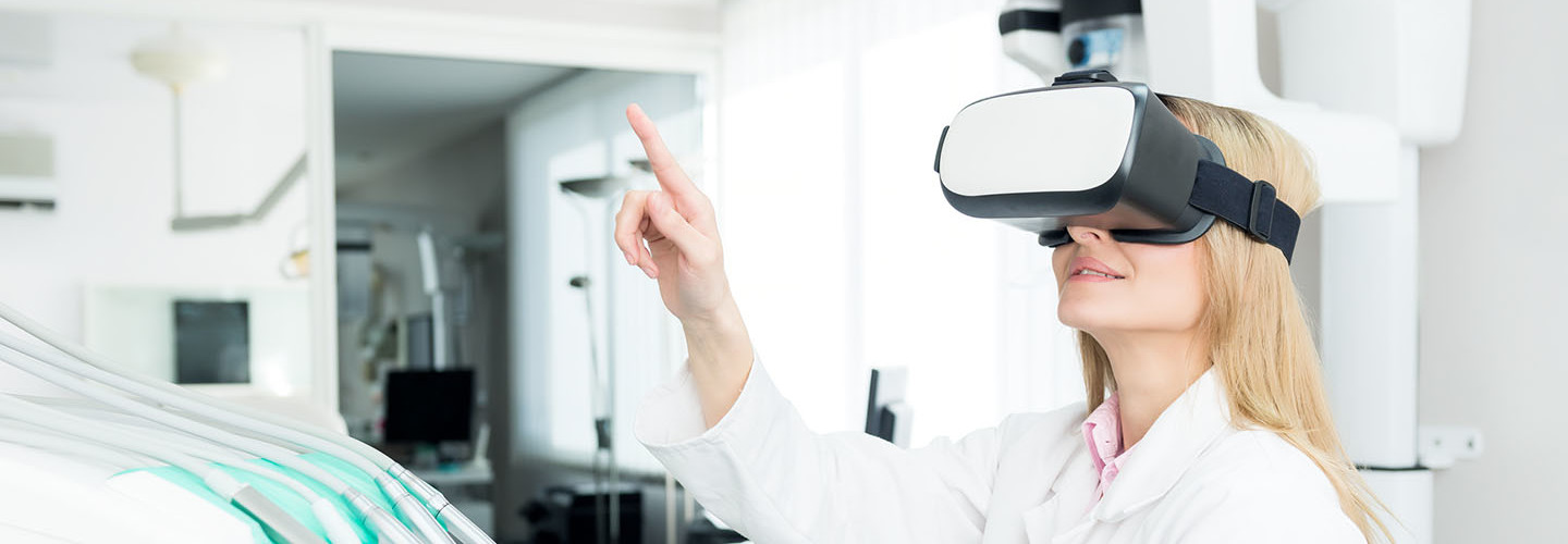 Horizontal color image of female dentist using virtual reality simulator at modern clinic.