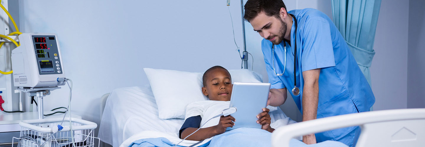 National Public Health Week — Male nurse and patient using digital tablet in ward