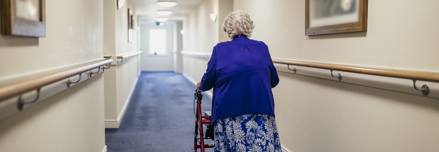 Senior walking in nursing home.