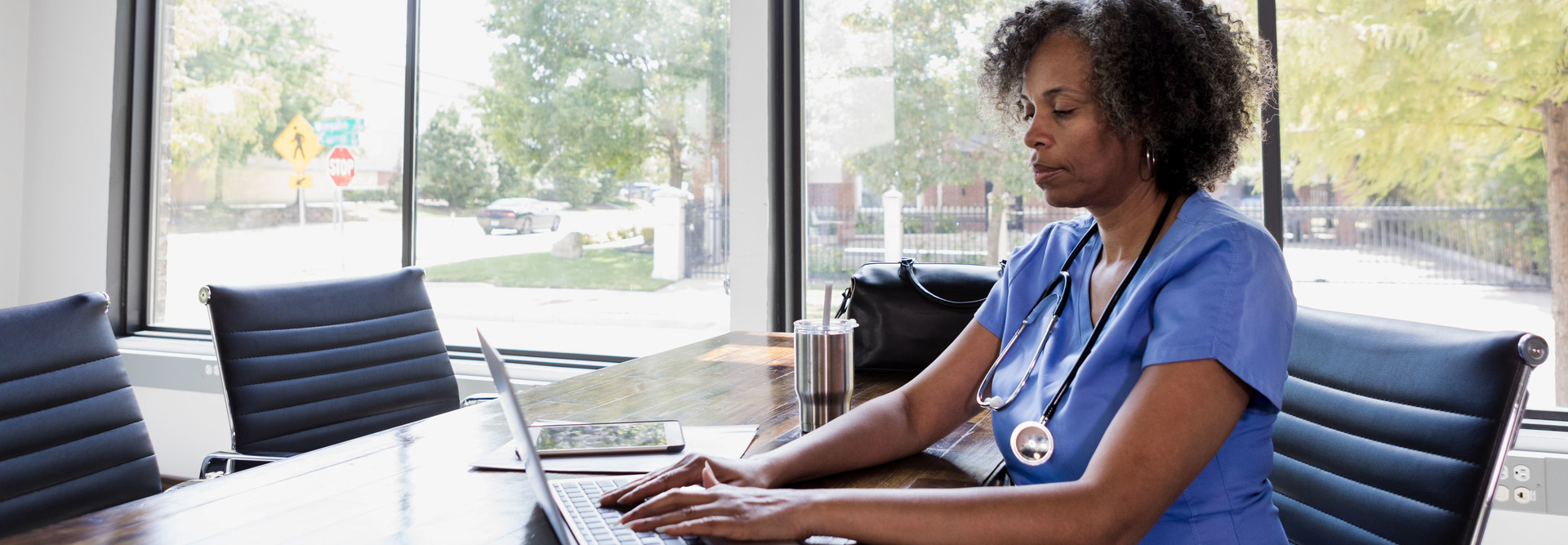 Nurse using laptop for telehealth