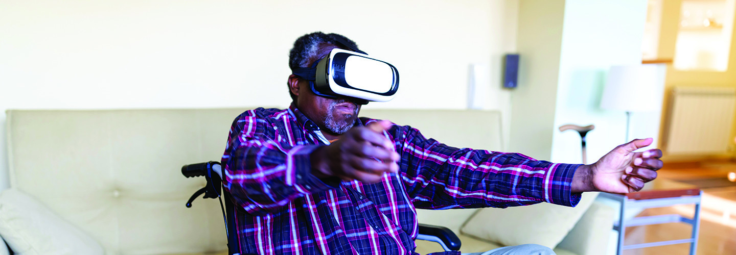 Senior man using VR headset