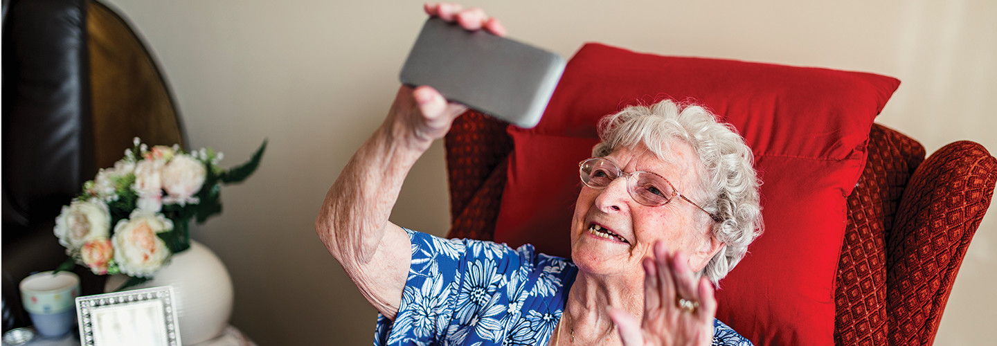 Elderly woman using a mobile telephone.
