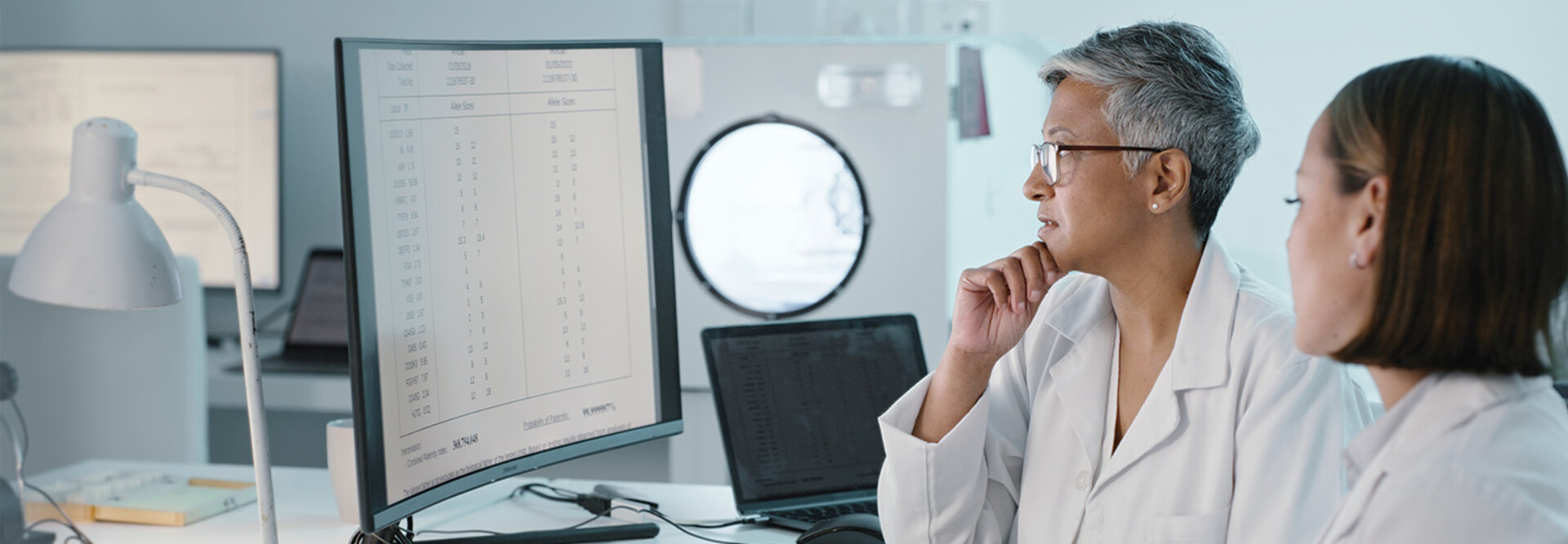 doctor's look at computer monitor together