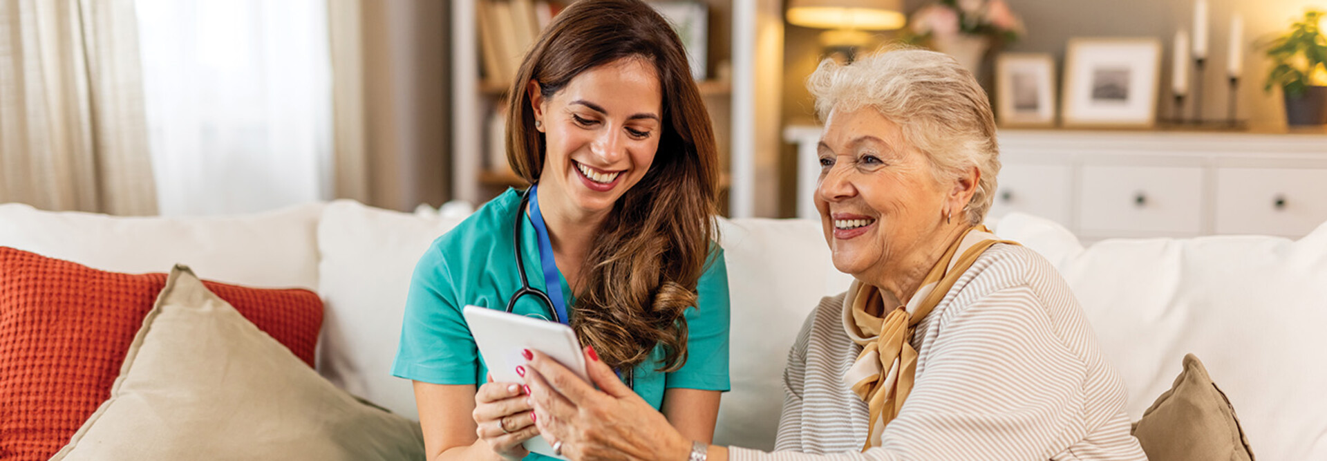 nurse and senior look at technology