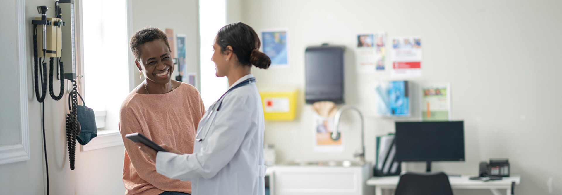 doctor and patient smiling at appointment
