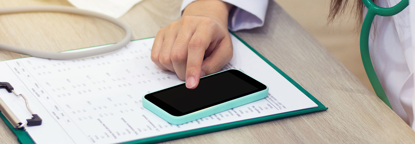 Doctor accesses patient data on smartphone as mobility in healthcare is on the rise