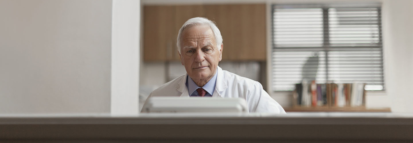 man at computer in doctor's office