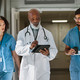 a doctor and two nurses walk together