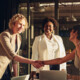 business leaders shake hands in conference room