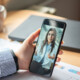 patient holds phone and speaks to doctor during telehealth appointment