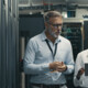 IT professionals look at tablet in data center room