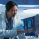 medical researchers looks at images on a monitor in a lab