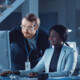 IT team confers over monitor