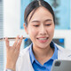 Doctor using phone to dictate to tablet