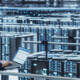 engineer with laptop overlooking data center