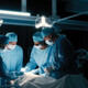 doctors perform surgery in a dark room