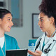 nurse and doctor collaborate over tablet