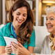 nurse and senior look at technology