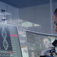 scientist looks at DNA on a computer